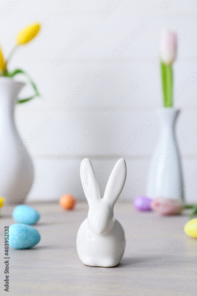 Easter eggs, figure of bunny and flowers on table Easter eggs, figure of bunny and flowers on table