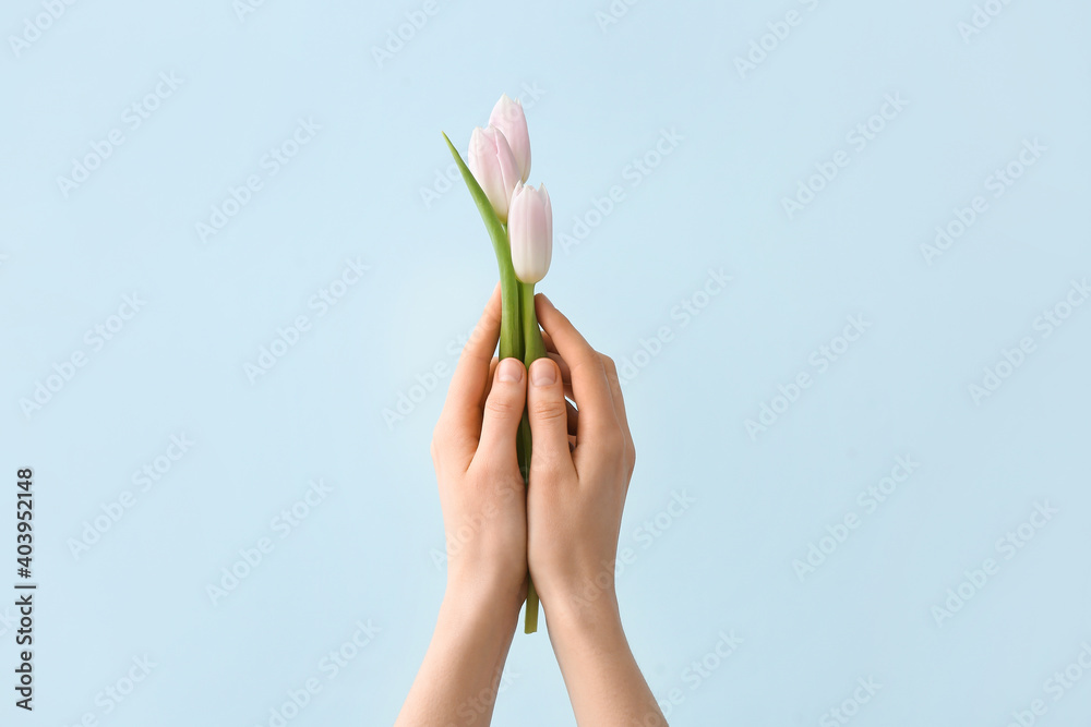Hands with bouquet of beautiful flowers on color background Hands with bouquet of beautiful flowers on color background