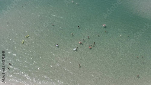 tourists swim in the clear sea.
