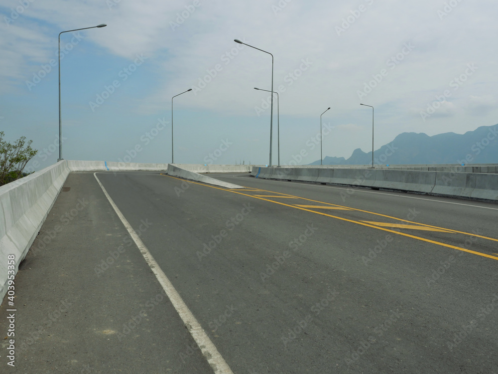 Open road on the bridge with mountain and blue sky in background, Southeast Asia, Thailand Open road on the bridge with mountain and blue sky in background, Southeast Asia, Thailand