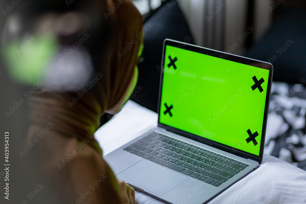 Islamic woman use laptop with greenscreen.