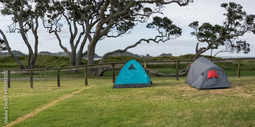 Camping with two tents on Otamure bay campsite on the north island of New Zealand