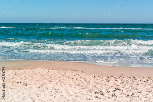 Landscape of sandy coast and sea with waves