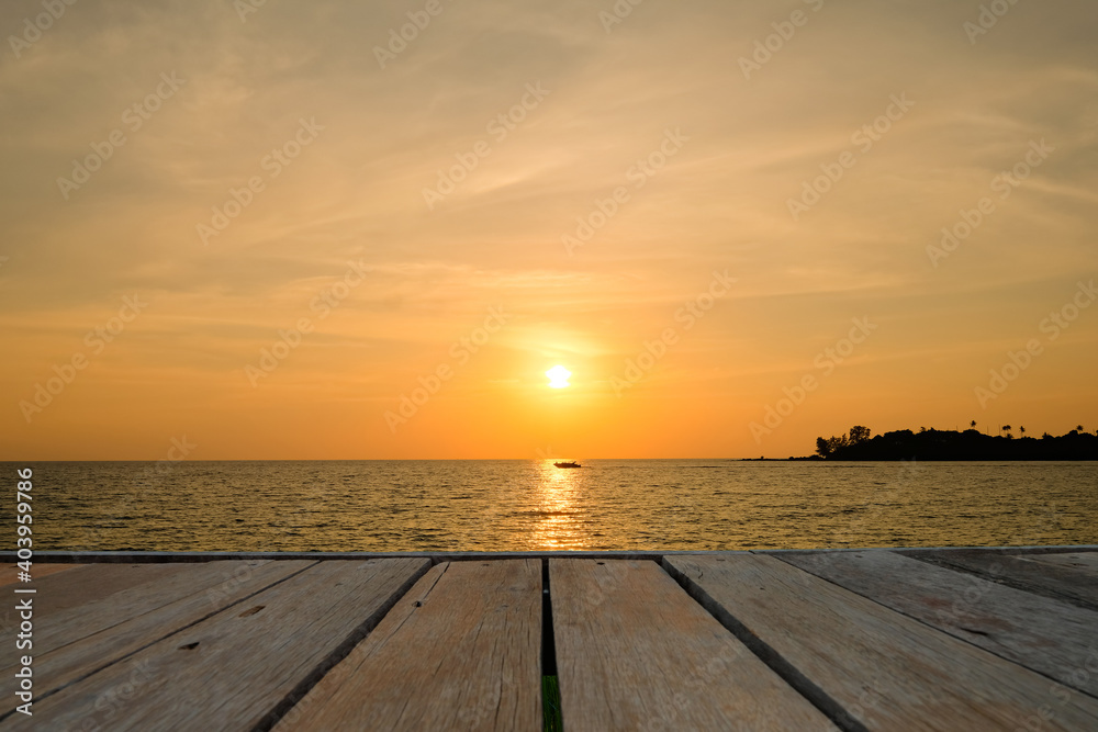 Beautiful landscape view of golden sky and white clouds in sunset with brown wooden table 