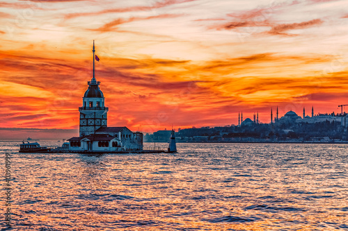 Obraz na płótnie A deep orange sunset paints the sky behind the Maidens Tower in Istanbul Turkey. w salonie