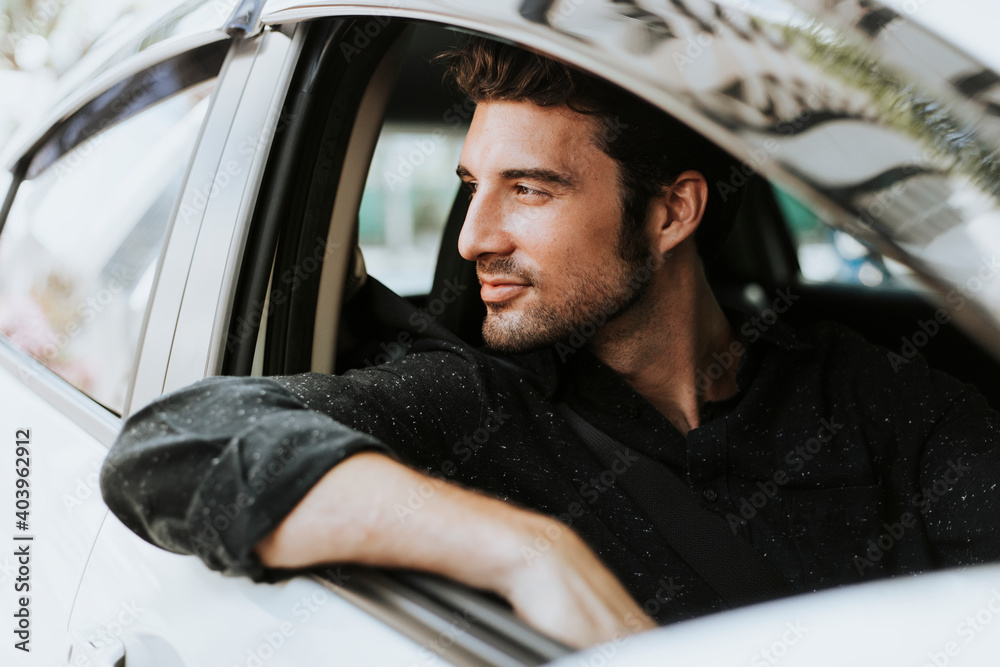 Handsome male driver sitting in a car - obrazy, fototapety, plakaty 