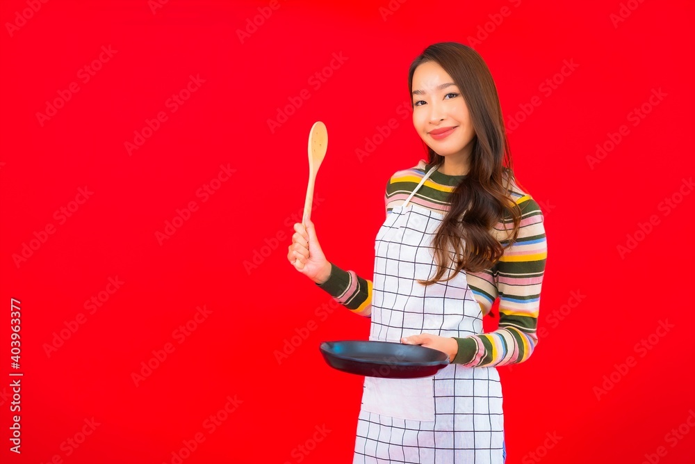 Portrait beautiful young asian woman with pan ready to cook Portrait beautiful young asian woman with pan ready to cook