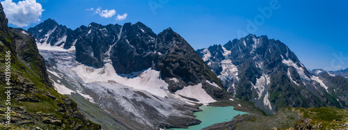 wide mountain landscape, small emerald lake near the mountain glacier © Yuriy Kulik