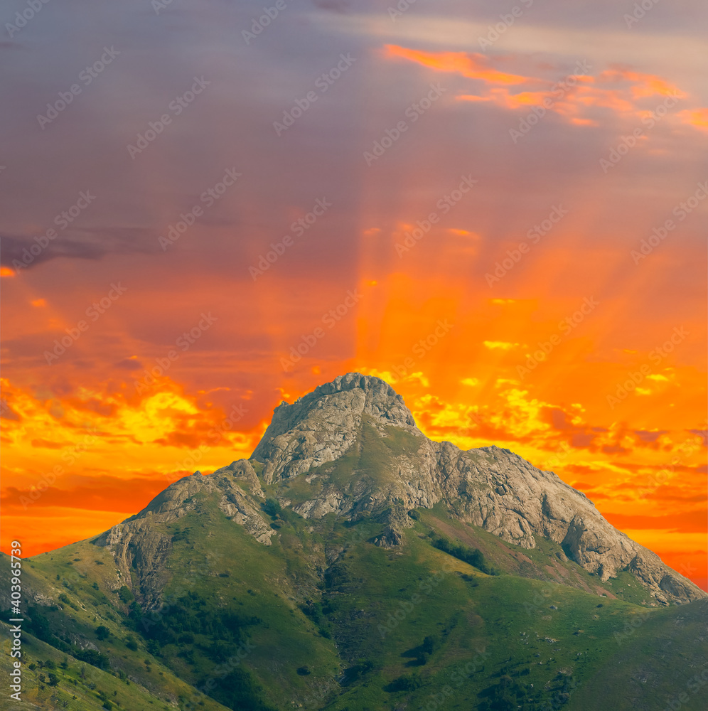 Fototapeta premium alone mount top on the red dramatic sunset background