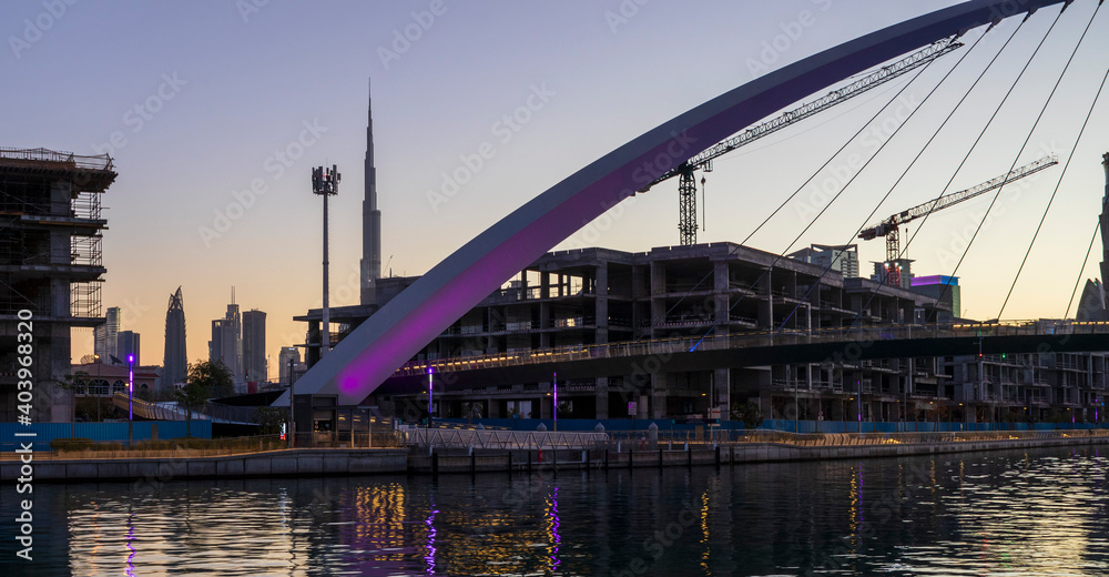 Obraz premium Dubai, UAE - 01.08.2021 Bridge over a Dubai Water canal known as Tolerance bridge. Outdoors