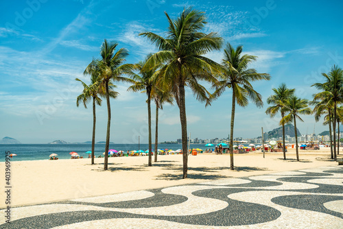 Sunny day on Copacabana Beach with palm trees in Rio de Janeiro, Brazil