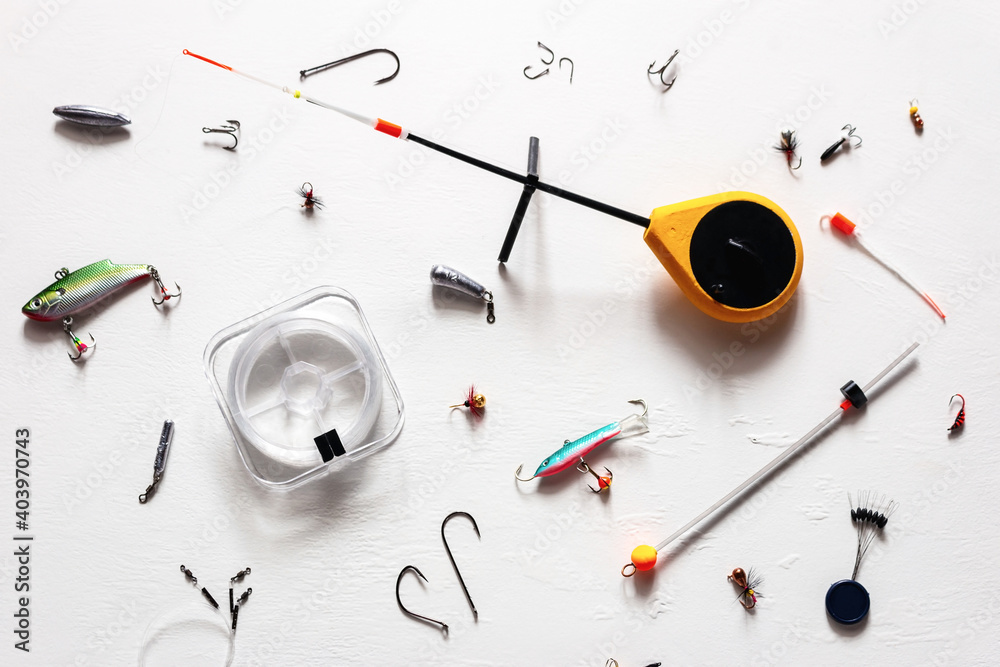 fishing rod, lures and other items for winter fishing on a white background fishing rod, lures and other items for winter fishing on a white background