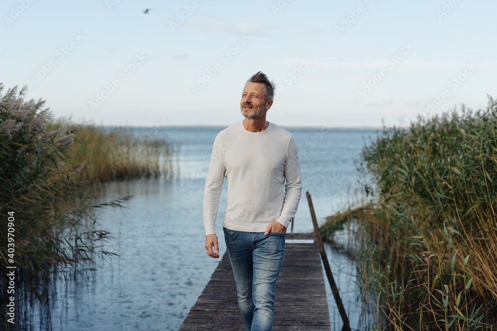 Attractive middle-aged man posing on a jetty