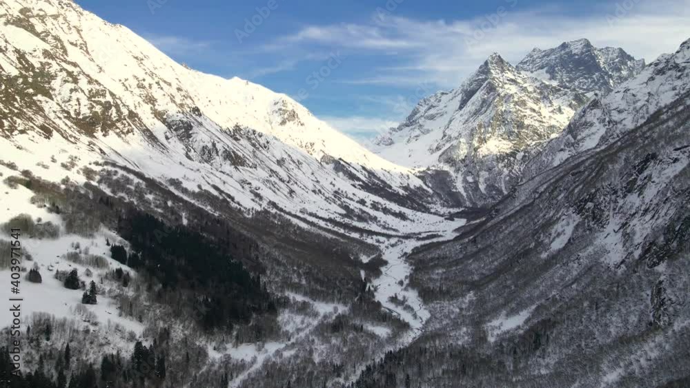 Majestic snow-capped mountains and forest. Location Dombay, Russia Majestic snow-capped mountains and forest. Location Dombay, Russia