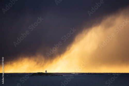 Massive storm over a little lighthouse island in arctic Norway