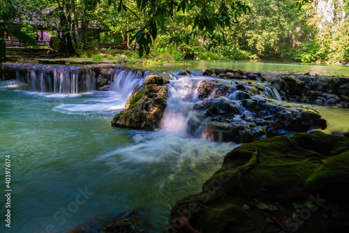 Beautiful waterfall in tropical rainforest green tree background