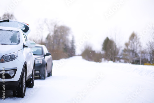 Modern car stay on roadside of winter road. Family trip to ski resort concept. Winter or spring holidays adventure. car on winter snowy road