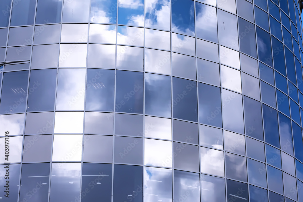 Architectural detail of the facade with multiple reflections of other buildings and the sun. Modern building. Architecture background Architectural detail of the facade with multiple reflections of other buildings and the sun. Modern building. Architecture background