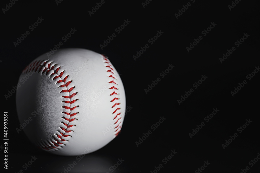 American traditional sports game. Baseball. Concept. Baseball ball and bats on a black table.