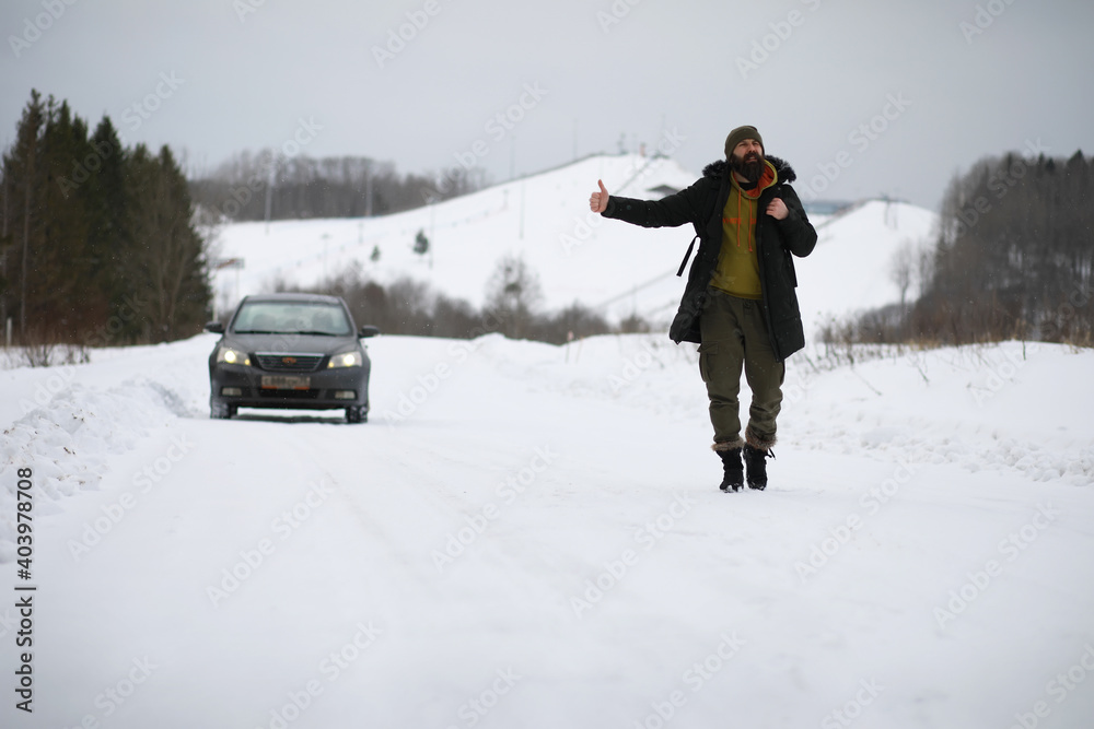 Tourists travel through the snowy country. On the way, walk and hitchhike.