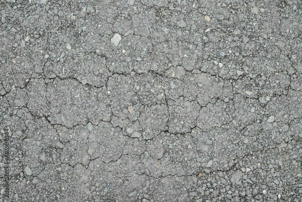 Old worn asphalt road with cracks texture Old worn asphalt road with cracks texture