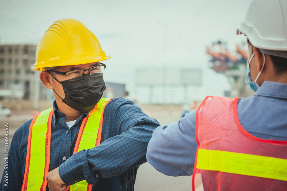 Two worker shake hand elbow prevention covid19 coronavirus, Man wear face mask Two worker shake hand elbow prevention covid19 coronavirus, Man wear face mask