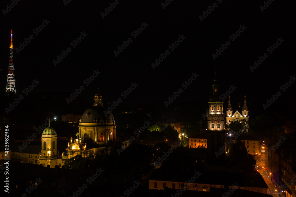 Aerial view on Dormition, Dominican and Carmelite Church in Lviv, Ukraine at night from drone