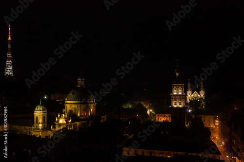 Aerial view on Dormition, Dominican and Carmelite Church in Lviv, Ukraine at night from drone