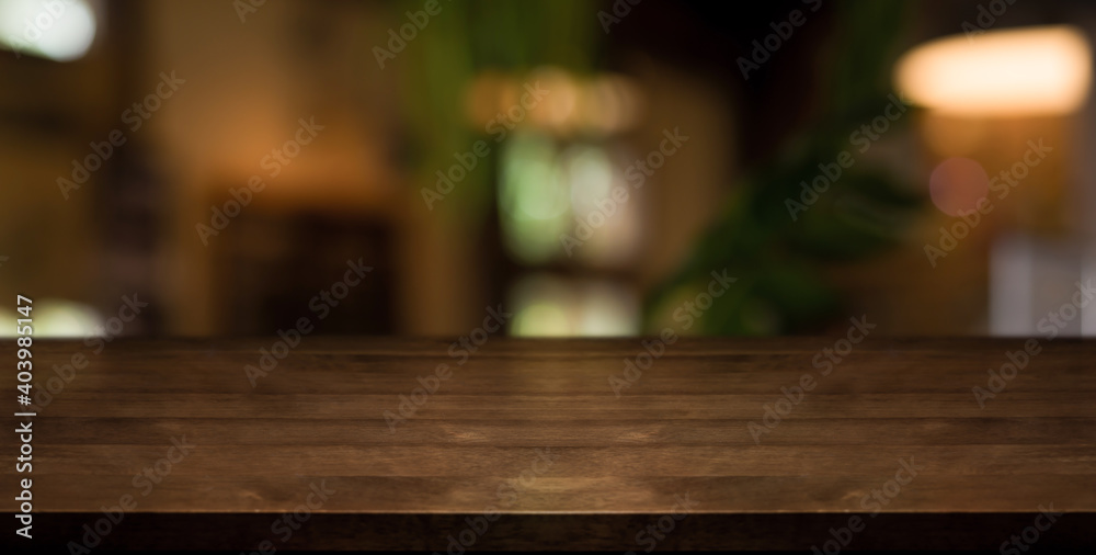 Empty wooden table top with lights bokeh on blur restaurant background. Empty wooden table top with lights bokeh on blur restaurant background.