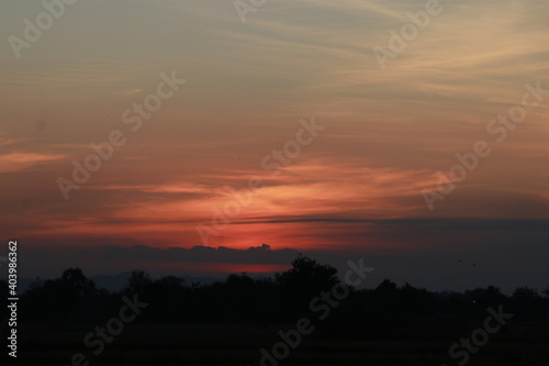 The Orange light of Sunrise ,silhouette and blue sky in the morning