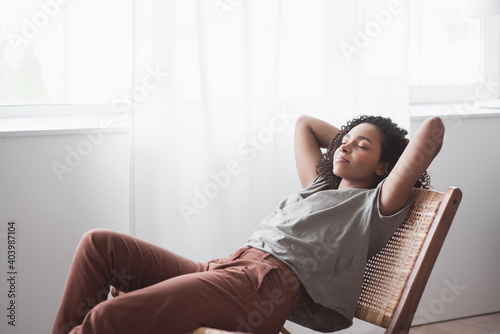 Young woman relaxing at home. African american girl resting in her room. Enjoy life, rest, relaxation, wellbeing, lifestyle, people, recreation concept