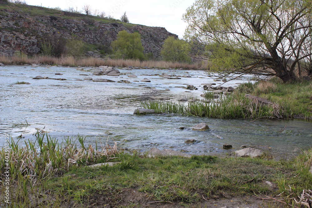River with large granite stones. Steppe. Nature