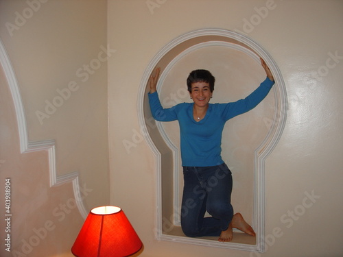 Fototapeta Portrait Of Smiling Woman In Alcove At Home
