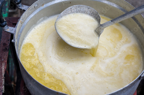 Ladle  scoop green curry in pot , cooking Thai food