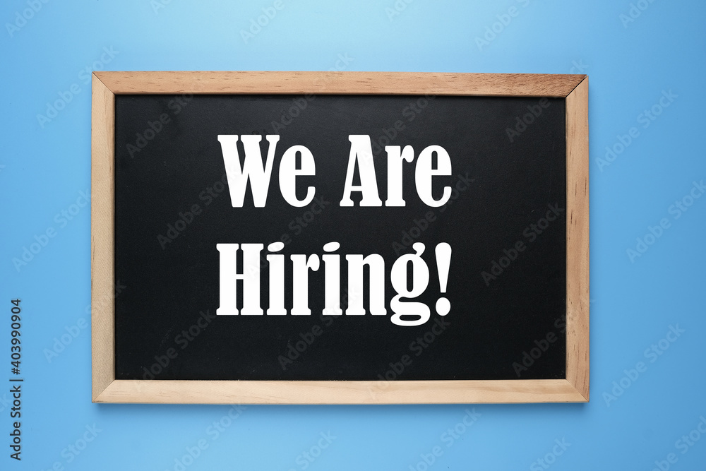 A picture of  blackboard written we are hiring on blue background.