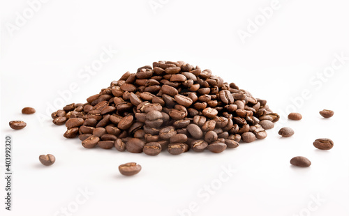 Pile of roasted coffee beans on a white background 