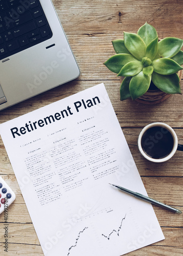 Retirement Plan. Calculator, pen and notebook on wooden table