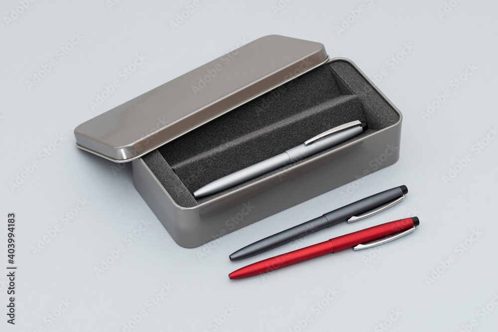 Gray pencil box and pens. Gray pencil box and pens.