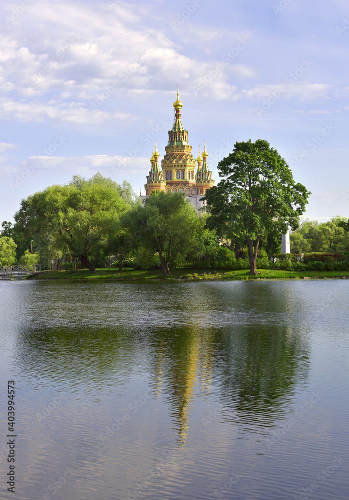 Kolonistsky Park in Peterhof. Cathedral of Saints Peter and Paul in the Russian architectural style of the XIX century on the Bank of Olga pond