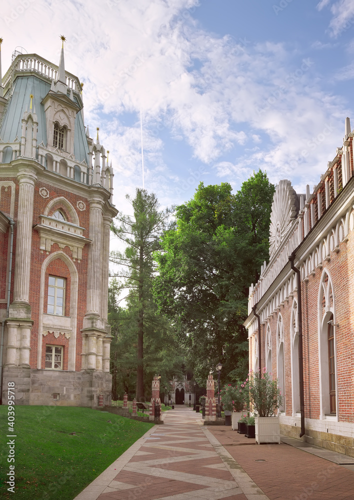 In Tsaritsyno Park. Palace and Park ensemble of the XVIII century, architect Vasily Bazhenov. A tall tower with a mansard roof and columns, red brick, white stone, Gothic styling