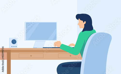 Woman sitting at desktop and communicating with laptop. Female worker in headset working with computer wireless device. Professional employee back with with pc on workplace