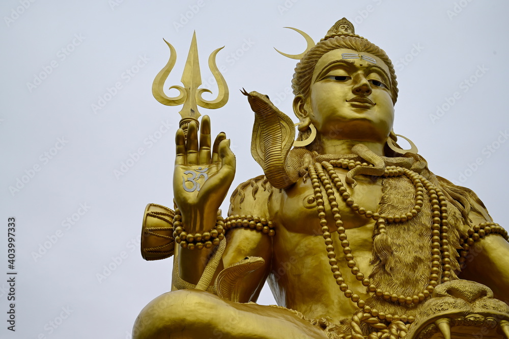 Lord Shiva statue large and bright golden in Father Shiva Temple at Ram Inthra 71 km 8, Bangkok Lord Shiva is the supreme deity in the universe, one of the trinity or the three supreme deities
