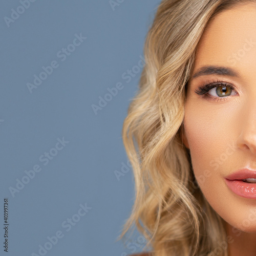 Close-up portrait of beautiful and young woman posing in studio.