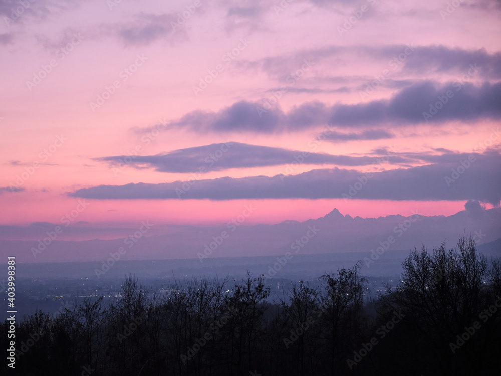 profile of the Monviso alp overlooks the Po Valley immersed in a pink sky profile of the Monviso alp overlooks the Po Valley immersed in a pink sky