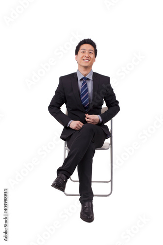 A Cheerful young business man sitting posture 