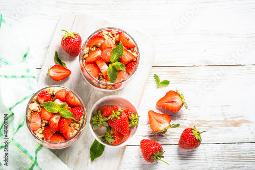 Greek yogurt with fresh strawberry and granola. Top view with copy space.
