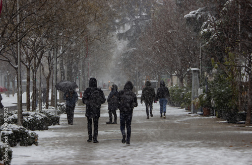 people walking in winter with snow in Madrid