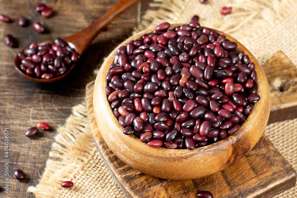  Red beans. Raw red beans in a wooden bowl on a brown wooden table. Organic Natural Vegetarian product
