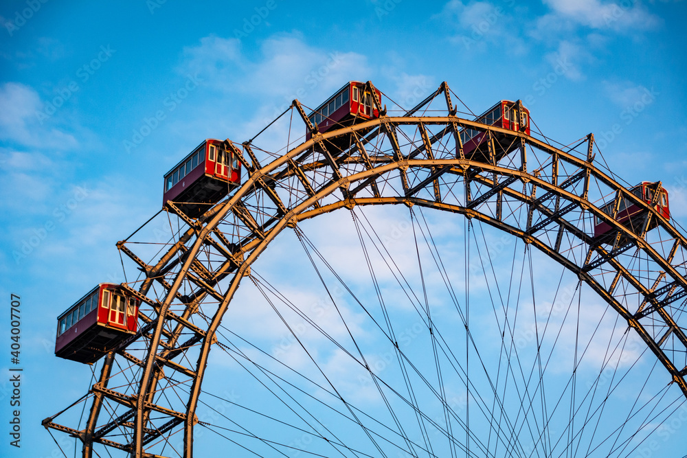 Historic Ferris wheel of the famous Vienna Prater Park with its wooden red carriages. One of the main sighting points in Vienna, Austria