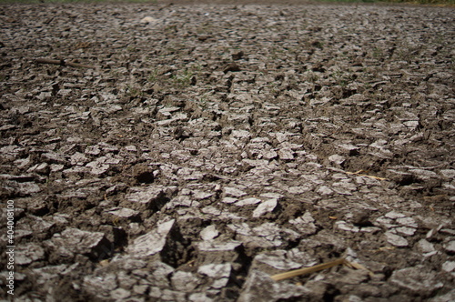 Dry lake or swamp in the process of drought and lack of rain or moisture, a global natural disaster. The cracked soil of the earth